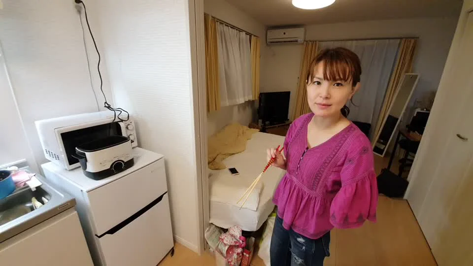 The on-camera participant standing in a kitchen and holding chopsticks in the archived video Cooking with Chihiro