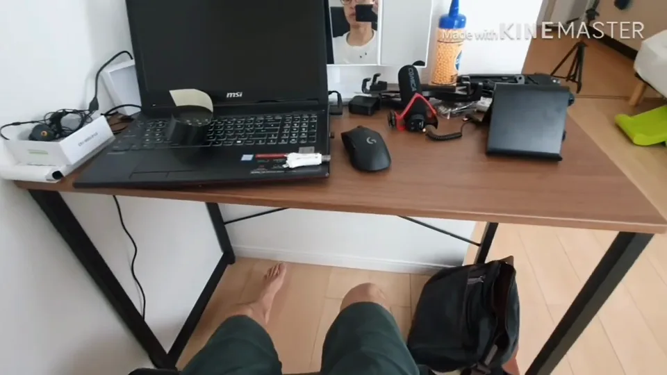 A desk and mirror showing Daniel holding a camera during the July 2019 response video