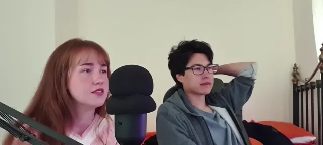 Two participants seated on camera with a large microphone between them in the archived stream with sunny video